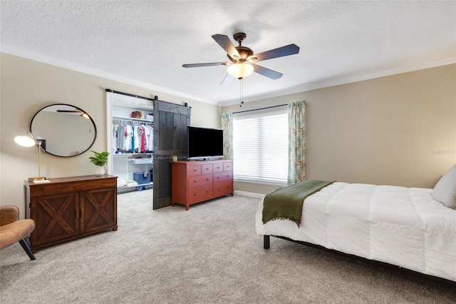 6819 Broken Arrow Trl S, Lakeland, FL 33813 - bedroom with light colored carpet, crown molding, a textured ceiling, a barn door, and ceiling fan