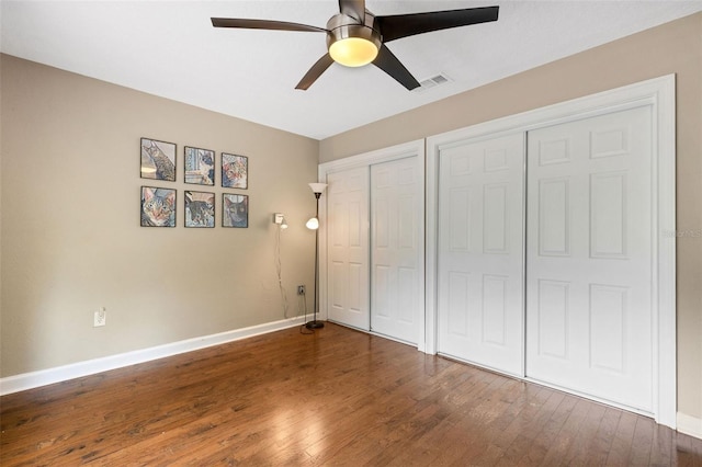 6819 Broken Arrow Trl S, Lakeland, FL 33813 - unfurnished bedroom with wood finished floors, multiple closets, and ceiling fan