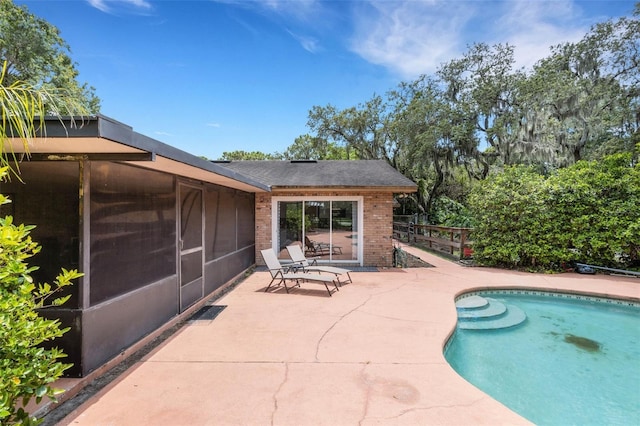6819 Broken Arrow Trl S, Lakeland, FL 33813 - outdoor pool with a patio and a sunroom