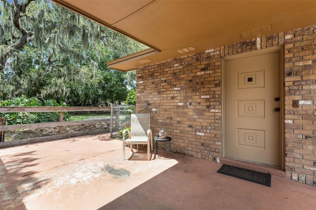 6819 Broken Arrow Trl S, Lakeland, FL 33813 - property entrance featuring brick siding and a patio area