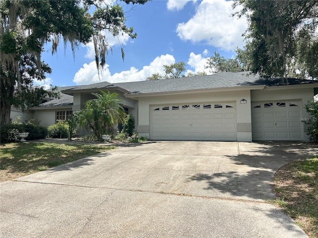 1909 Masters Way, Plant City, FL 33566 - ranch-style home with an attached garage, stucco siding, and concrete driveway