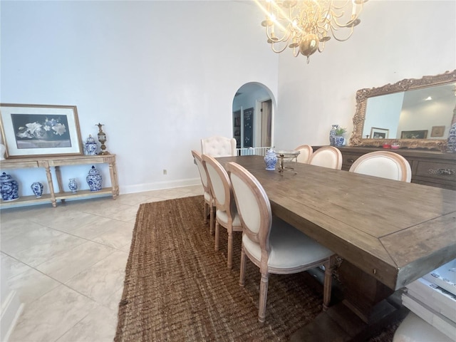 1909 Masters Way, Plant City, FL 33566 - dining area featuring arched walkways, a chandelier, light tile patterned floors, and a towering ceiling