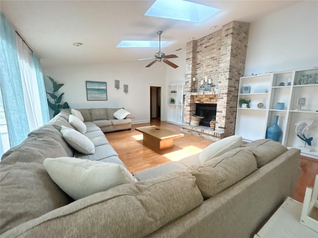 1909 Masters Way, Plant City, FL 33566 - living area featuring a skylight, wood finished floors, a fireplace, ceiling fan, and high vaulted ceiling