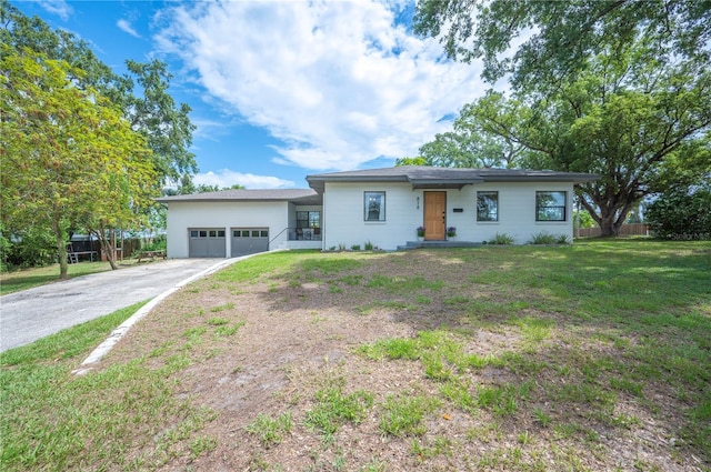 818 Woodward St, Lakeland, FL 33803 - view of front of house featuring asphalt driveway, an attached garage, and a front lawn