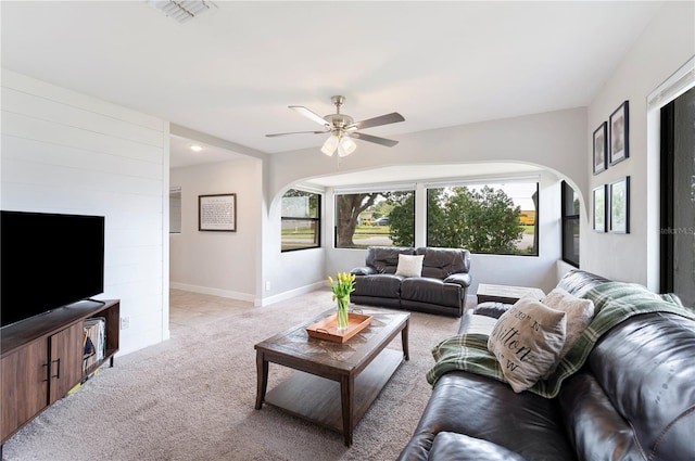 818 Woodward St, Lakeland, FL 33803 - living room with arched walkways, light colored carpet, healthy amount of natural light, and a ceiling fan