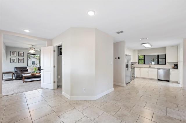 818 Woodward St, Lakeland, FL 33803 - kitchen featuring appliances with stainless steel finishes, light countertops, healthy amount of natural light, white cabinets, and recessed lighting