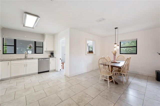 818 Woodward St, Lakeland, FL 33803 - dining space with light tile patterned floors and baseboards