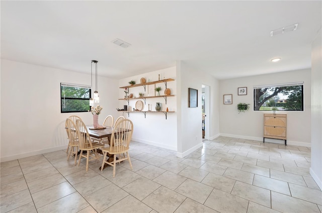 818 Woodward St, Lakeland, FL 33803 - dining room featuring light tile patterned floors and baseboards