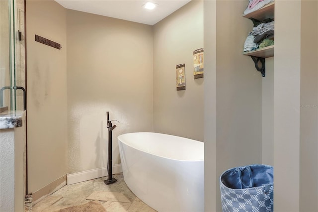 1300 Ariana Woods Cir, Auburndale, FL 33823 - full bathroom featuring a freestanding tub and stone finish floors
