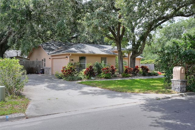 1300 Ariana Woods Cir, Auburndale, FL 33823 - view of front of house with stucco siding, a garage, and asphalt driveway