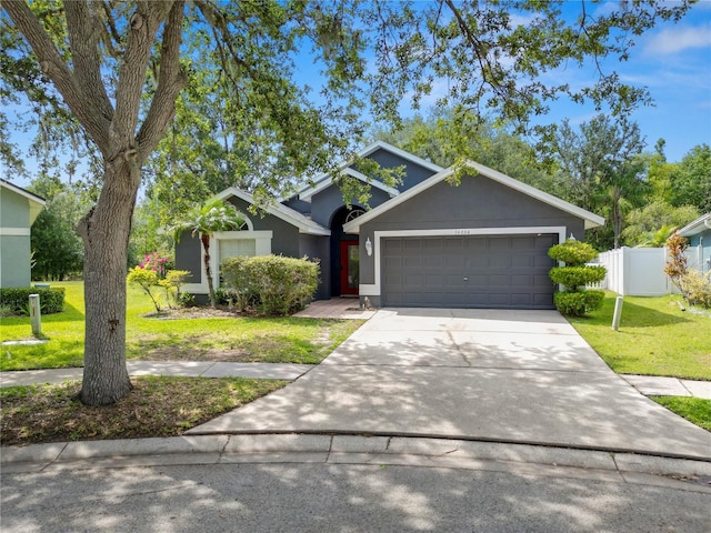 16804 Hawkridge Rd, Lithia, FL 33547 - view of front of house featuring a garage, driveway, and stucco siding