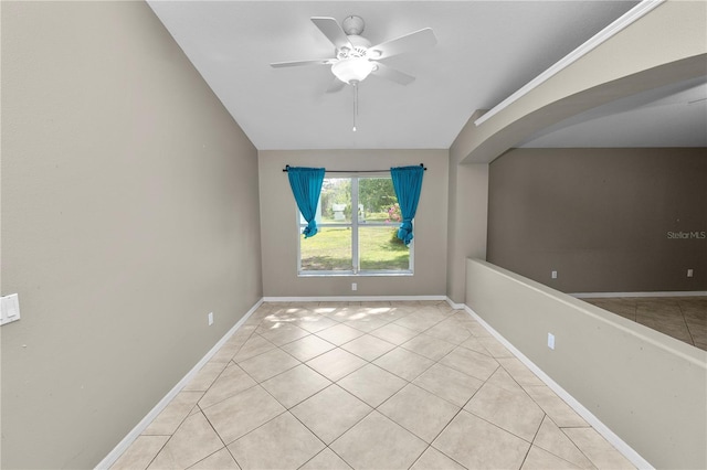 16804 Hawkridge Rd, Lithia, FL 33547 - spare room featuring light tile patterned floors, ceiling fan, baseboards, and arched walkways