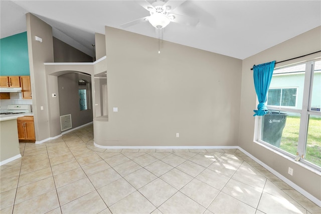 16804 Hawkridge Rd, Lithia, FL 33547 - empty room featuring arched walkways, a ceiling fan, vaulted ceiling, light tile patterned flooring, and plenty of natural light