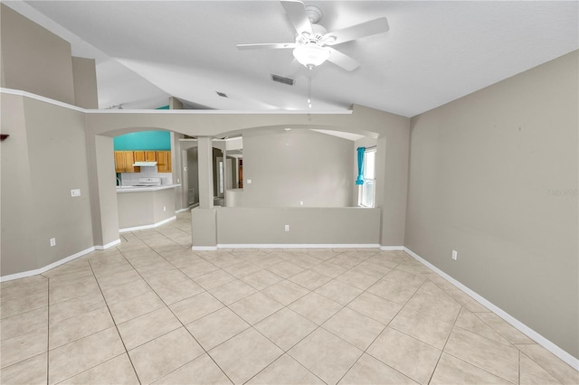 16804 Hawkridge Rd, Lithia, FL 33547 - unfurnished room featuring a ceiling fan, lofted ceiling, light tile patterned floors, arched walkways, and baseboards