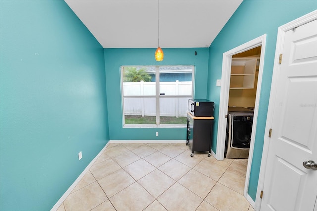 16804 Hawkridge Rd, Lithia, FL 33547 - unfurnished dining area featuring washer / clothes dryer, baseboards, and light tile patterned flooring
