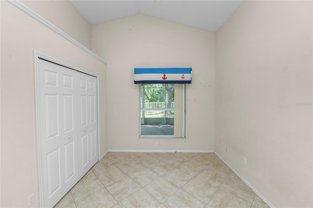 16804 Hawkridge Rd, Lithia, FL 33547 - unfurnished bedroom with light tile patterned flooring, vaulted ceiling, a closet, and baseboards