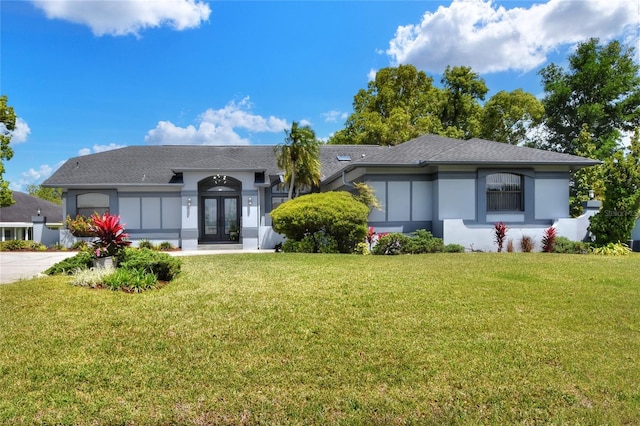 8721 Latham Ln, Hudson, FL 34667 - view of front of house with french doors, stucco siding, and a front lawn