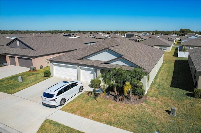 2929 Flying Blackbird Rd, Bartow, FL 33830 - view of front of property with roof with shingles, an attached garage, concrete driveway, and a residential view