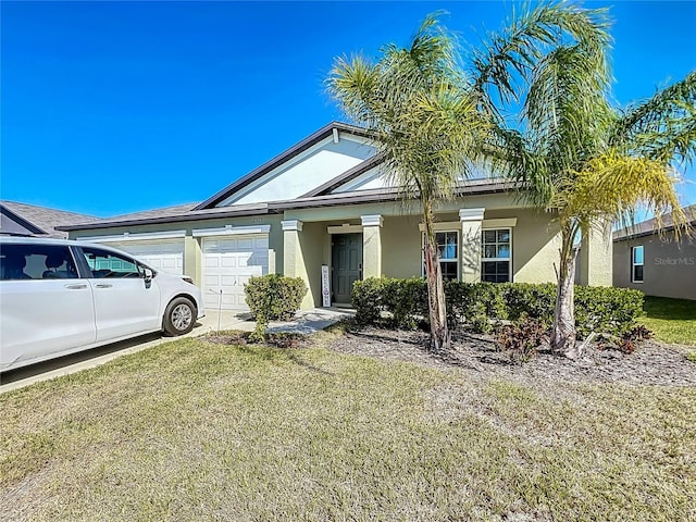 2929 Flying Blackbird Rd, Bartow, FL 33830 - view of front of home featuring an attached garage, stucco siding, and a front yard