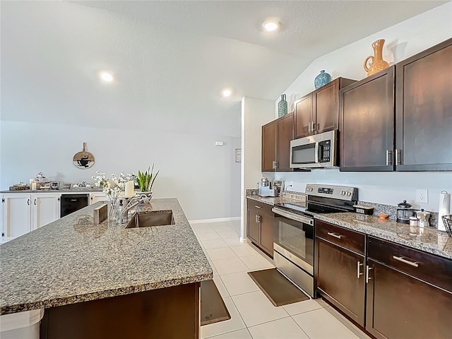 2929 Flying Blackbird Rd, Bartow, FL 33830 - kitchen with appliances with stainless steel finishes, light tile patterned flooring, a sink, vaulted ceiling, and dark brown cabinetry