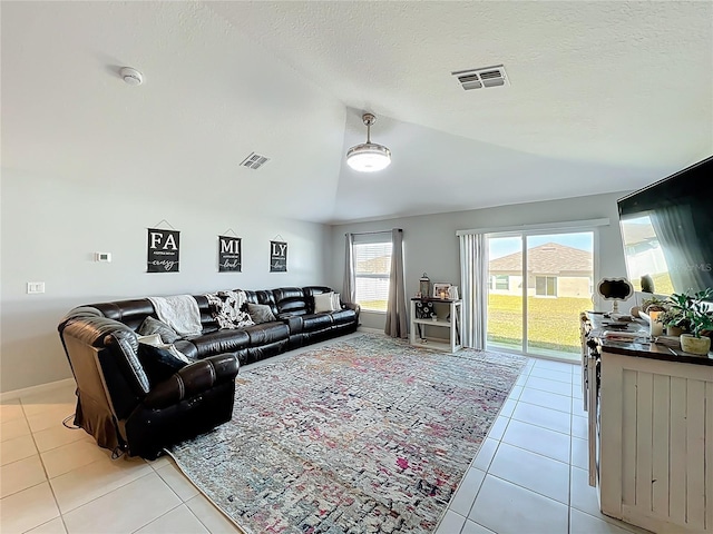 2929 Flying Blackbird Rd, Bartow, FL 33830 - living area with vaulted ceiling, light tile patterned floors, a textured ceiling, and baseboards