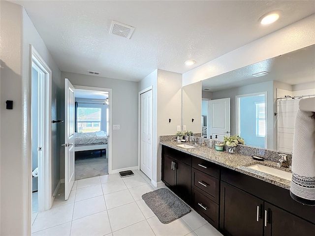 2929 Flying Blackbird Rd, Bartow, FL 33830 - bathroom featuring double vanity, baseboards, connected bathroom, tile patterned floors, and a shower