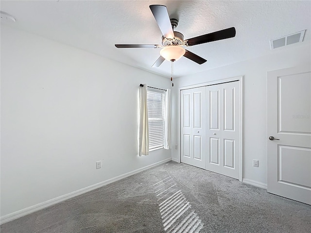 2929 Flying Blackbird Rd, Bartow, FL 33830 - unfurnished bedroom featuring carpet, baseboards, a closet, a ceiling fan, and a textured ceiling