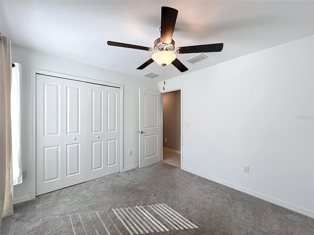 2929 Flying Blackbird Rd, Bartow, FL 33830 - unfurnished bedroom featuring carpet, a closet, baseboards, a ceiling fan, and a textured ceiling