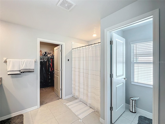 2929 Flying Blackbird Rd, Bartow, FL 33830 - bathroom with tile patterned floors, a walk in closet, baseboards, and curtained shower