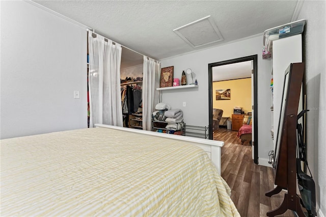 3016 Reiter Dr, Auburndale, FL 33823 - bedroom with dark wood finished floors, attic access, a textured ceiling, and a closet