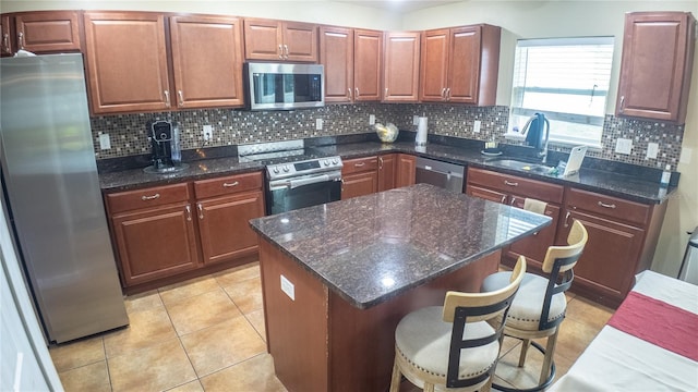 2170 Forest Lake Ave, Dundee, FL 33838 - kitchen with stainless steel appliances, tasteful backsplash, a breakfast bar, and a kitchen island