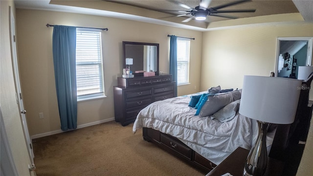2170 Forest Lake Ave, Dundee, FL 33838 - bedroom with a tray ceiling, light colored carpet, and ceiling fan
