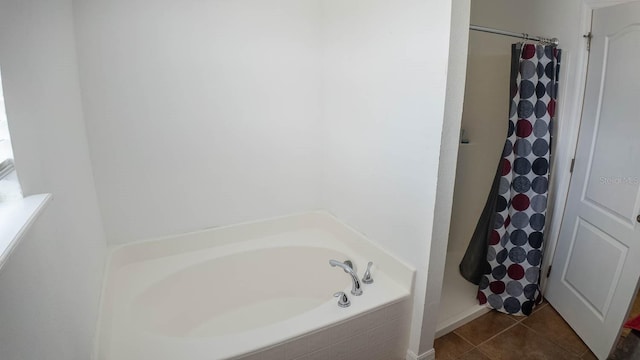 2170 Forest Lake Ave, Dundee, FL 33838 - bathroom featuring a shower with curtain, a bath, and tile patterned floors