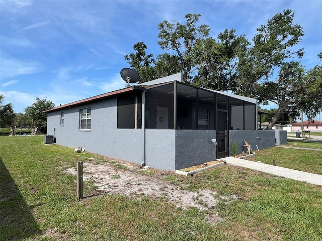 854 Shirley Ann Trl Unit 854/856, Lakeland, FL 33809 - view of home's exterior with central AC, a lawn, and stucco siding