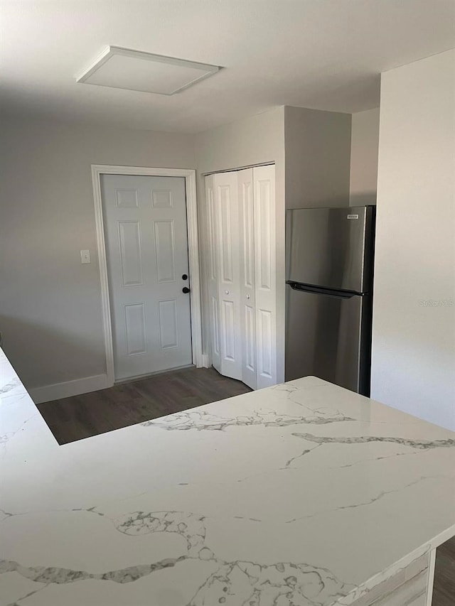 854 Shirley Ann Trl Unit 854/856, Lakeland, FL 33809 - kitchen with freestanding refrigerator, light stone countertops, dark wood-style flooring, and baseboards
