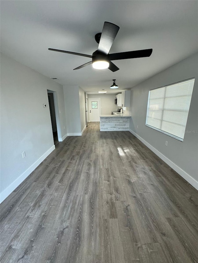 854 Shirley Ann Trl Unit 854/856, Lakeland, FL 33809 - unfurnished living room with a ceiling fan, dark wood-style flooring, and baseboards