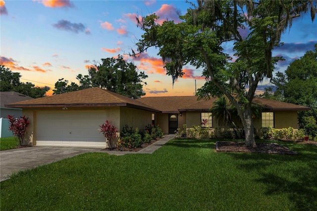 1917 Lori Ln W, Lakeland, FL 33801 - ranch-style home featuring a garage, concrete driveway, a front lawn, and stucco siding