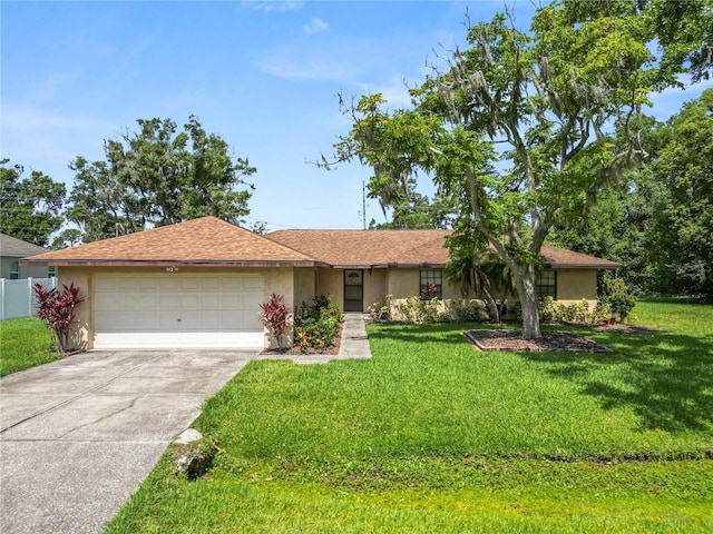 1917 Lori Ln W, Lakeland, FL 33801 - single story home with a garage, driveway, a front yard, and stucco siding