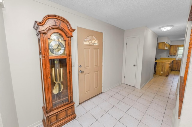 1917 Lori Ln W, Lakeland, FL 33801 - entrance foyer featuring a textured ceiling, light tile patterned floors, and baseboards