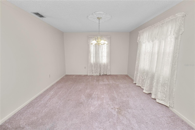1917 Lori Ln W, Lakeland, FL 33801 - carpeted empty room featuring a chandelier, a textured ceiling, and baseboards