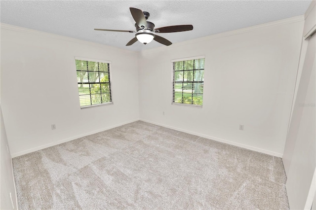 1917 Lori Ln W, Lakeland, FL 33801 - carpeted empty room featuring a textured ceiling, healthy amount of natural light, crown molding, a ceiling fan, and baseboards