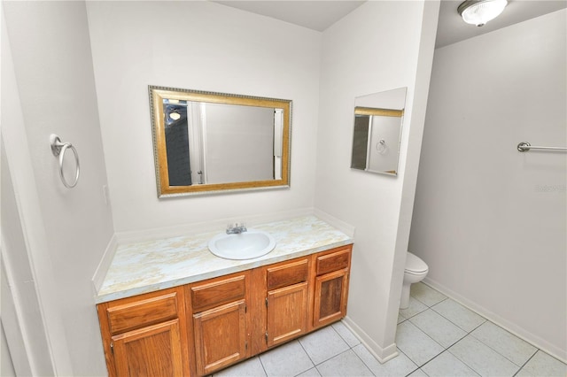 1917 Lori Ln W, Lakeland, FL 33801 - bathroom featuring vanity, toilet, tile patterned floors, and baseboards