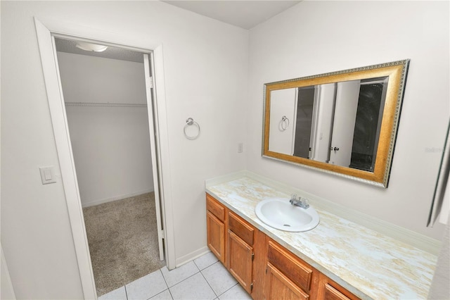 1917 Lori Ln W, Lakeland, FL 33801 - bathroom with vanity, tile patterned flooring, baseboards, and a walk in closet