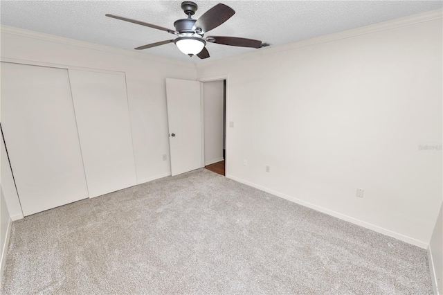 1917 Lori Ln W, Lakeland, FL 33801 - unfurnished bedroom featuring a textured ceiling, carpet, a closet, a ceiling fan, and baseboards