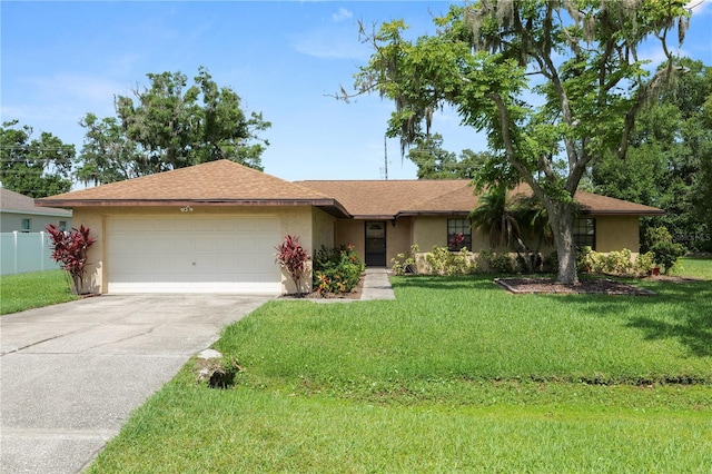 1917 Lori Ln W, Lakeland, FL 33801 - ranch-style house featuring a garage, stucco siding, driveway, and a shingled roof