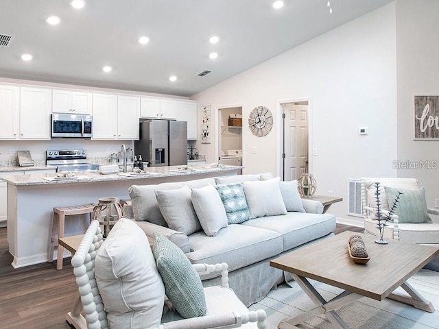 7019 161st Ter E, Parrish, FL 34219 - living area featuring recessed lighting, dark wood-style flooring, vaulted ceiling, and baseboards