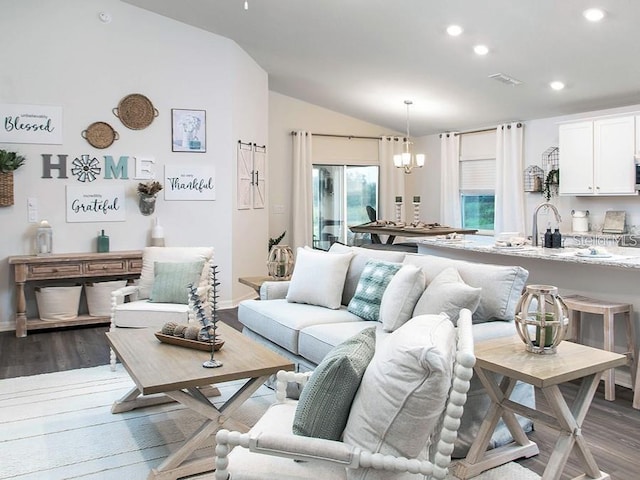 7019 161st Ter E, Parrish, FL 34219 - living area with vaulted ceiling, wood finished floors, recessed lighting, baseboards, and a chandelier