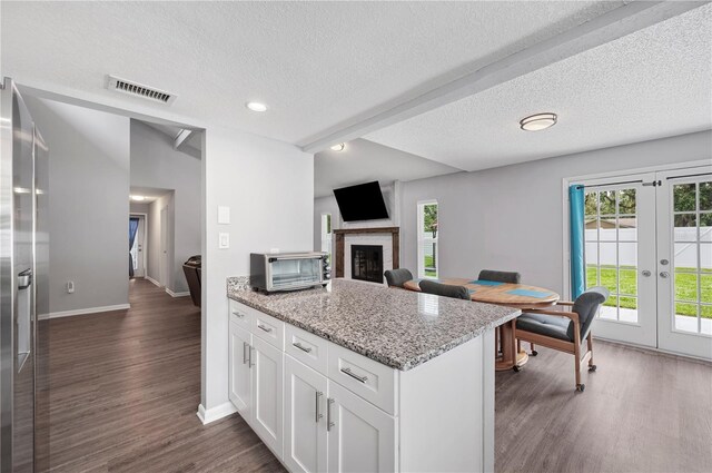 3080 Cross Fox Dr, Mulberry, FL 33860 - kitchen with french doors, baseboards, healthy amount of natural light, dark wood-style flooring, and a textured ceiling