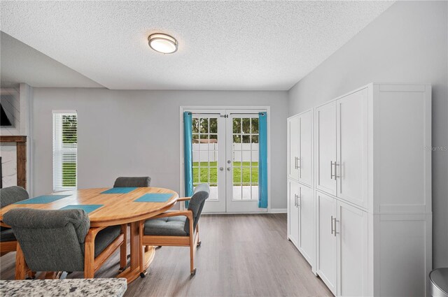 3080 Cross Fox Dr, Mulberry, FL 33860 - dining space with french doors, light wood-style flooring, and a textured ceiling