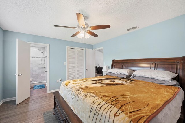 3080 Cross Fox Dr, Mulberry, FL 33860 - bedroom with baseboards, wood finished floors, a closet, a textured ceiling, and connected bathroom